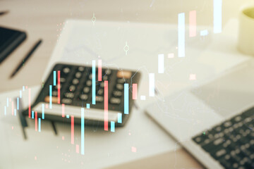 Multi exposure of virtual abstract financial graph interface on blurry calculator and computer background, financial and trading concept