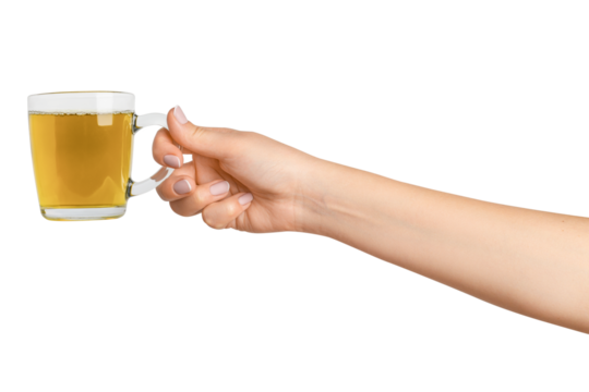 A woman's hand holds a cup of green herbal tea in a transparent glass cup. On a blank background