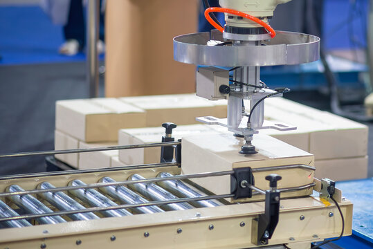 The paper box container handling process by robotic system. The high technology material handling process by robotic arm.