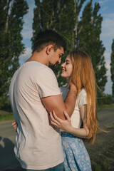 Fototapeta premium Cropped portrait of couple hugging and laughing cheerfully against the nature background. Togetherness concept.