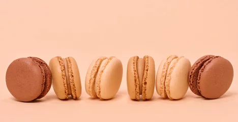 Stickers fenêtre Macarons Chocolate macarons on a beige background, dessert