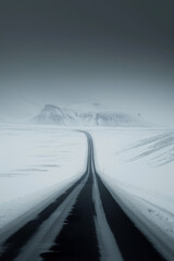 The road leading to the distance in the snowy mountains.