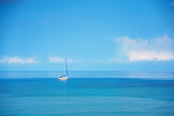 Beautiful yacht sailing boat on the sea with blue sky.