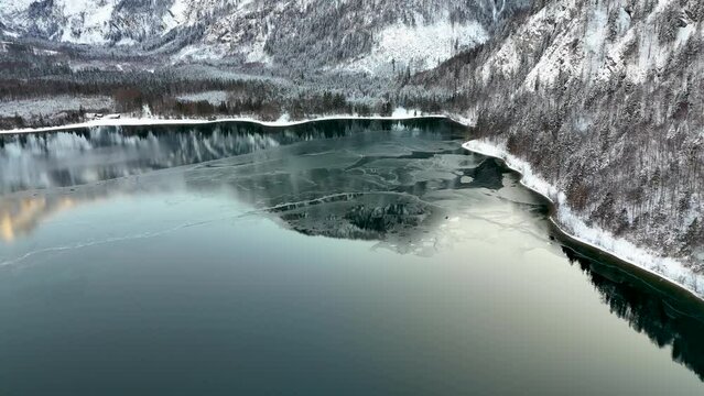 Drohnenflug &uuml;ber dem See in den Bergen in sch&ouml;ner Landschaft im Winter im Salzkammergut