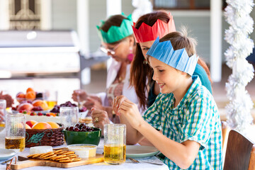 happy nine year old boy at dessert table at Christmas time with family