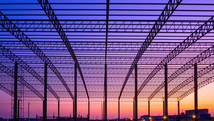 Silhouette of curve metal roof beam and column of large factory building outline structure in...