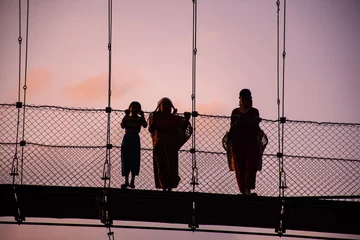 Fototapeten Silhouettes of people at a bridge © Ashlesh