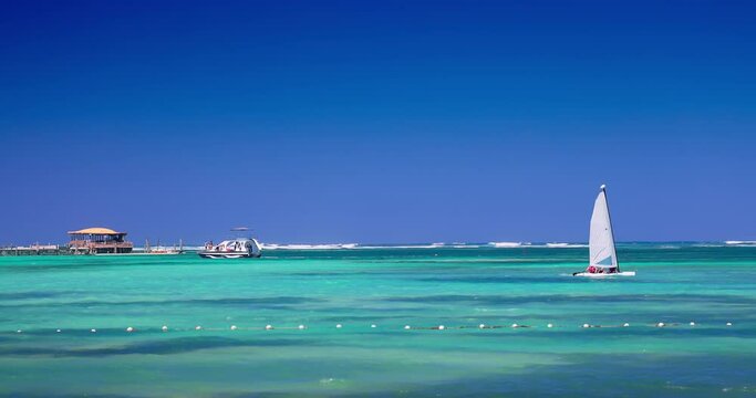 Sailing catamaran boat and yacht in caribbean sea water during sunny day, tropical summer vacation 4k Video