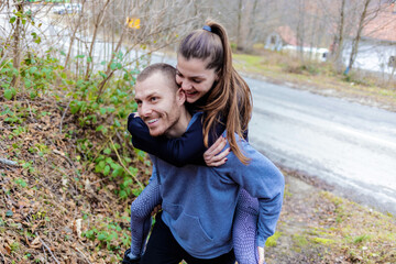 Fitness, nature and portrait of couple piggyback outdoors for exercise, training and cardio...