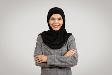 Confident businesswoman in hijab and business suit smiling