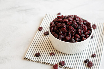 Organic Dried Cranberries in a Bowl, side view. Copy space.