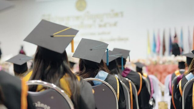 Aerial view of graduates wearing caps and gowns Congratulated the graduates in University Rear view of the university graduates in graduation gowns and caps