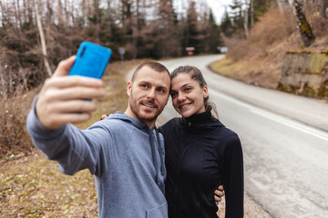 Selfie, fitness and young couple in road after a running exercise for race or marathon training....