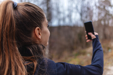 Fitness, phone selfie and young woman in park for workout, exercise and healthy lifestyle. Happy female, sports influencer and athlete taking mobile photograph for social media, wellness and goals.