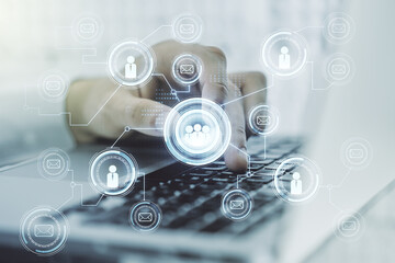 Double exposure of social network icons concept with hand typing on computer keyboard on background. Networking concept