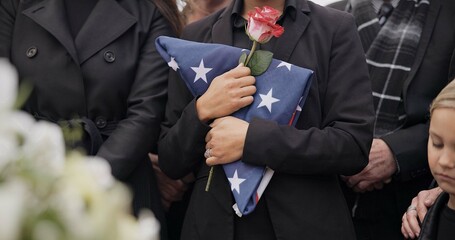 Funeral, graveyard and woman with American flag for veteran for respect, ceremony and memorial...