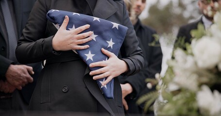 Hands, american flag and death with a person at a funeral, mourning a loss in grief at a graveyard....