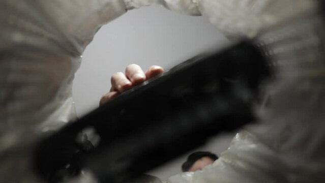 throwing a video card in the trash bin, a computer video card in hand inside view trash bin