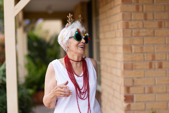 fun-loving octogenarian having fun dressed up fancy for Christmas