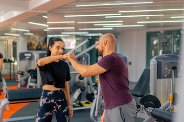 Fototapeta na wymiar girl fitness trainer and bodybuilder in the gym give each other a high five after a group workout
