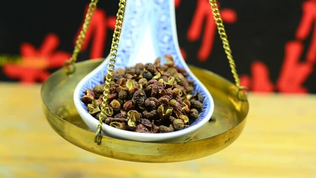 Szechuan pepper on a balance and macro view on a turn table