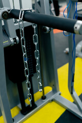 close-up of a metal bar hanging on a simulator in a gym equipment for training
