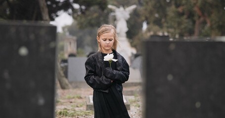 Fototapeta premium Flower, death or kid in cemetery for funeral. spiritual service or grave visit for repsect in Christian religion. Mourning, goodbye or sad girl child outside in graveyard for grief, loss or farewell