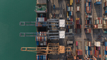 Global logistics business Aerial top view over an international cargo ship at the industrial import...