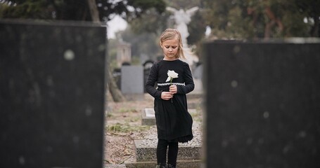 Sad, death or kid in cemetery for funeral. spiritual service or grave visit for respect in...
