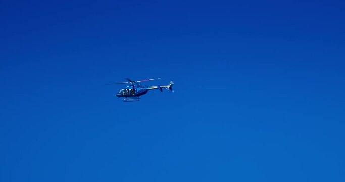 Flying helicopter in blue sky over caribbean sea 4k Video