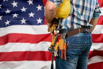 Fototapeta na wymiar Professional male labour with tools equipment at USA flag background