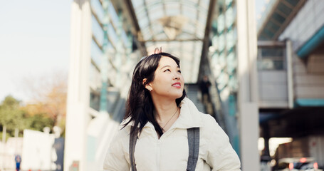 Walking, thinking and Japanese woman in city on commute, travel and journey in metro. Student,...