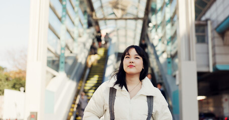 Walking, thinking and Japanese woman in city on commute, travel and journey in metro. Student,...