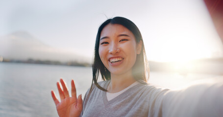 Japanese woman, selfie and happy outdoor, pointing at lake or river for social media and travel...