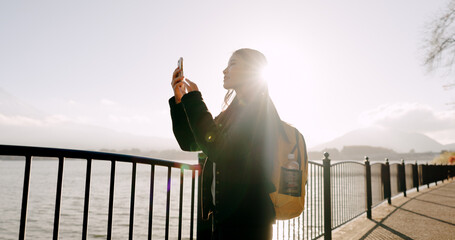 Japanese woman, lake and phone for photography, memory and post on web blog for travel with...