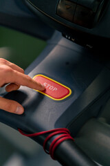 close-up of hand pressing stop button on treadmill after cardio workout technology sport