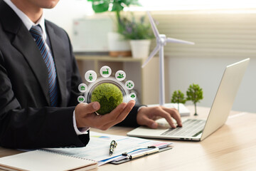 Sustainable business or green company concept. Businessmen holding green earth with green icons....