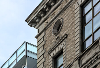 tall building detail in brooklyn, new york  (nyc tall old residential building next to new modern one)