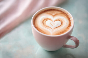 Glass of cappuccino with beautiful milk heart