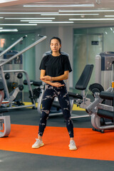 Fototapeta na wymiar young girl in sportswear in the gym doing body tilt exercises before training healthy lifestyle