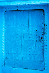 view of an old blue door in the blue city of Chefchaouen, Morocco