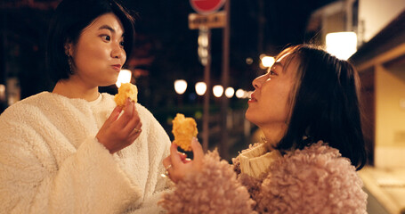 Woman, friends and street food or eating Japanese snack for travel experience, hungry or local...