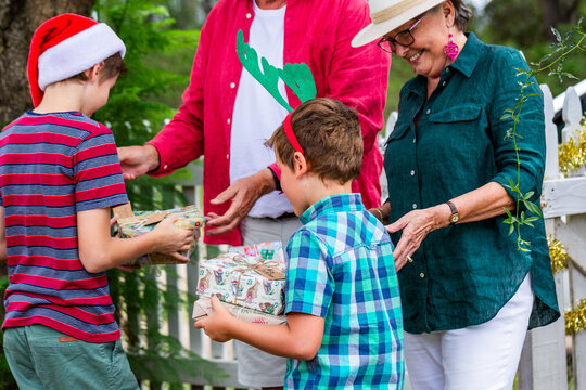 family members exchanging gifts at Christmas family gathering