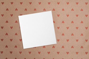 Blank square valentines day card mockup on craft paper background