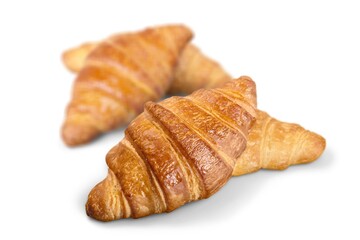 Tasty fresh golden croissant on desk