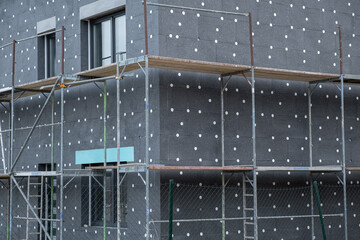 modern thermal insulation materials. building New House in process insulation of the wall of the...
