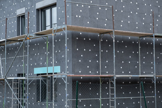 modern thermal insulation materials. building New House in process insulation of the wall of the house with layers Exterior covering in construction site.