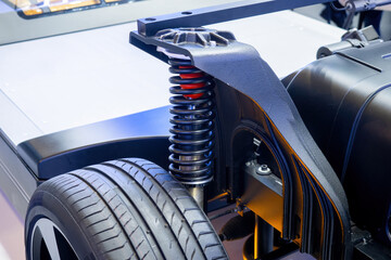 Car suspension spring. Automobile hydraulics close-up. Spring above car wheel. Suspension shock...