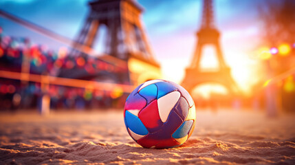 A multi-colored volleyball lies on sand against the backdrop of the Eiffel Tower during sunset,...