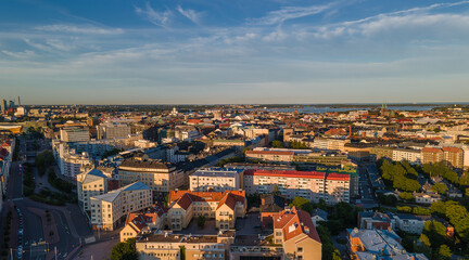 Fototapeta na wymiar Aerial close view to Helsinki central residental area. Multistory buildings. Colorful roofs in Scandinavia. Finland sunset
